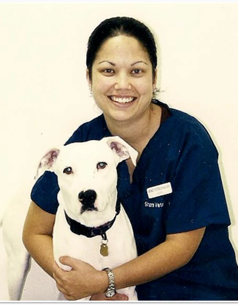 Dr. Moynahan with a white dog.